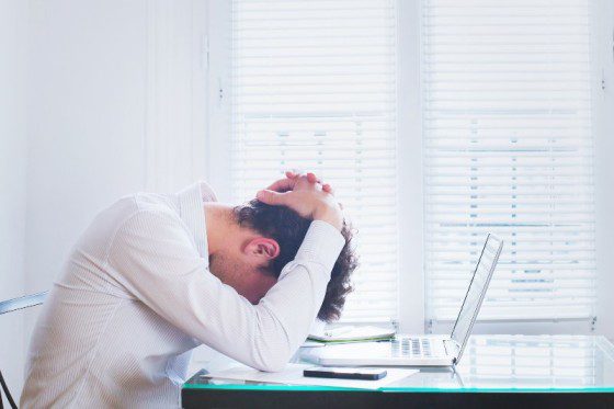 Canva Emotional burnout tired businessman at workplace in the office stress. 1