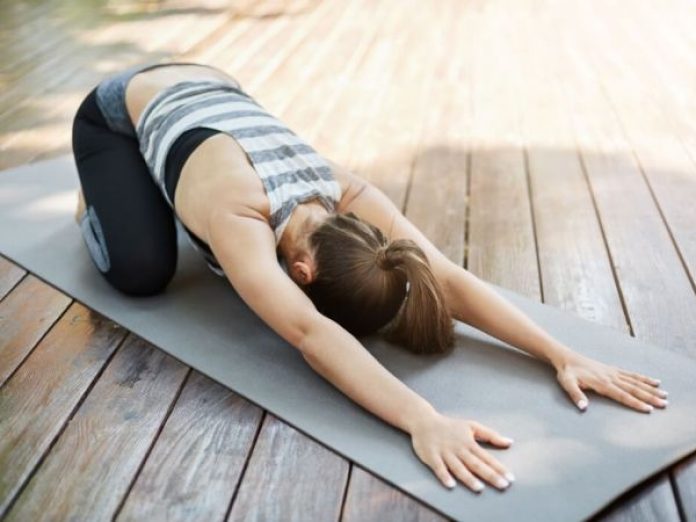 young woman stretching her back after long yoga session doing exercises her backyard neighbours envy1 600 450 80 s c1 1